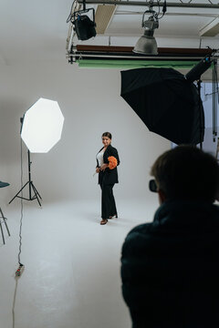 Professional studio photoshoot setup with model and lights