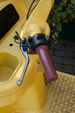 Close-up of an auto rickshaw handle in yellow vehicle