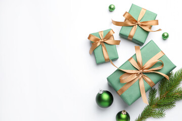 Beautiful Christmas composition with gifts and decor on white background, flat lay. Space for text