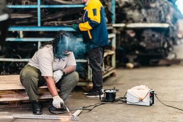 Female Welder Cutting Metal with Torch in Industrial Workshop