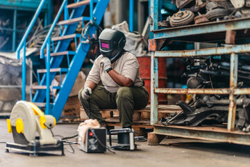 Female Welder Cutting Metal with Torch in Industrial Workshop
