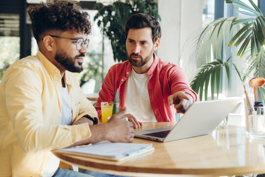 Successful, confident businessmen working together having break in cafe. Team brainstorming
