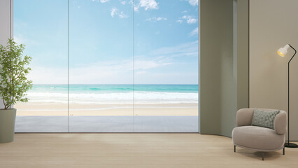 Minimalist living room with cozy armchair and floor lamp beside green plant 3d rendering. Blue sky ocean beach view through large glass wall of calm interior for vacation relaxation.