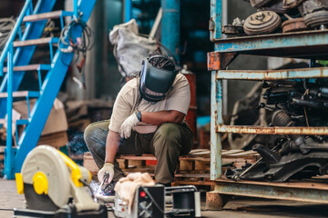 Female Welder Cutting Metal with Torch in Industrial Workshop