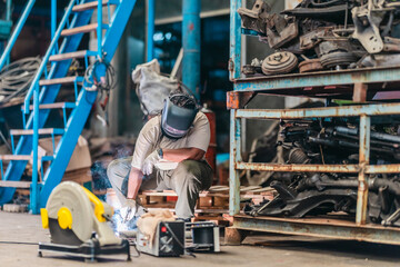 Female Welder Cutting Metal with Torch in Industrial Workshop