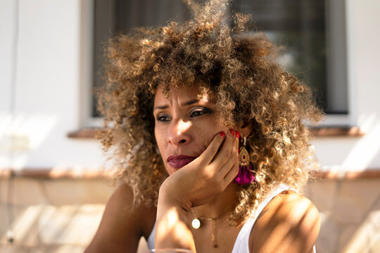 Thoughtful woman enjoying a sunny afternoon outdoors
