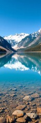 Fototapeta premium A tranquil lake reflecting snow-capped mountains and a clear blue sky, showcasing a perfect natural vista, tranquil, nature