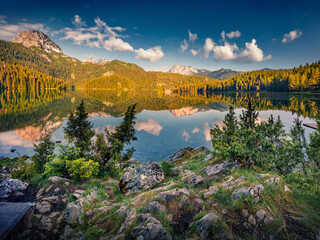 Deep blue sky reflected in the calm waters of Black Lake (Crno Jezero). Attractive summer scene of Durmitor Nacionalni Park, Zabljak location, Montenegro. Beauty of nature concept background.
