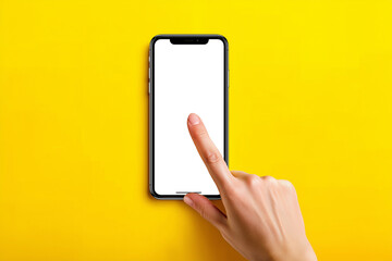 A hand holds a smartphone against a bright yellow background while another hand touches the blank screen.