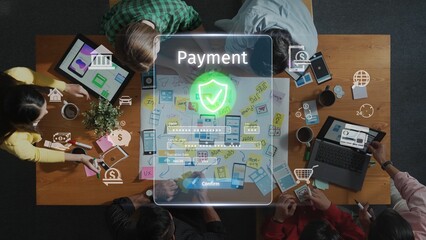A diverse group of individuals collaborates around a table, focusing on innovative digital payment solutions, symbolizing teamwork in financial technology. Raster