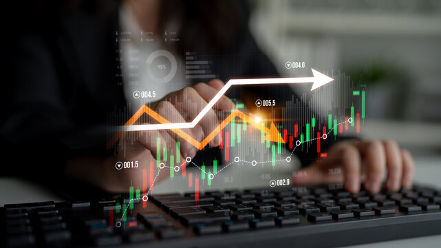 This image features a businesswoman typing on a keyboard with a stock market data graph overlay, symbolizing financial growth and investment strategy in a professional setting. Scalp - Powered by Adobe
