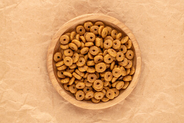 Dry dog ​​food on kraft paper, top view, macro.