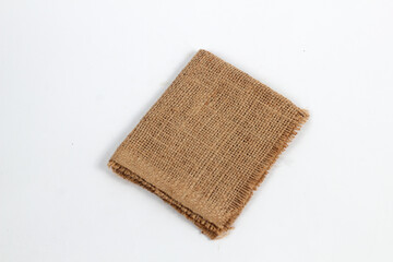 piece of rustic jute burlap fabric on a clean white background.