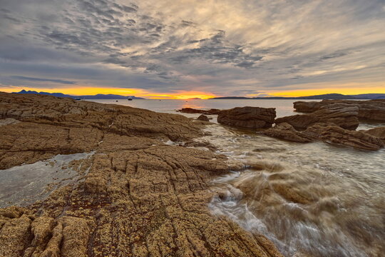 The colorful sundown paints in a reddish hue the Elgol village rocky beach and bay on Loch Scavaig, Strathaird peninsula. Isle of Skye-Scotland-096