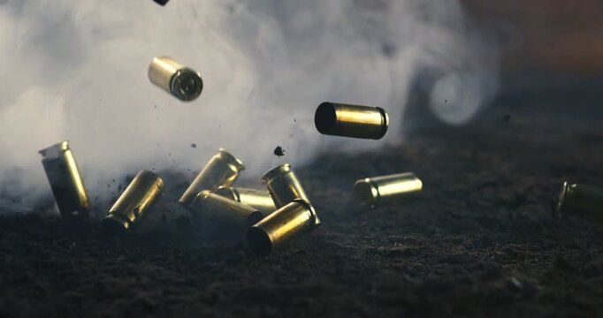 Handgun shells and bullets dropping on dusty terrain with swirling smoke, film-style lighting, recorded in 1000 fps high-speed slow motion.