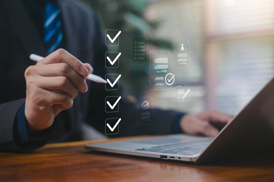 Businessman marking digital checkboxes on a laptop, showing task management, checklist review, verification process, modern digital workspace. check of document, list survey, form business