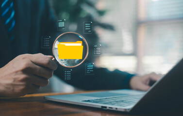 Businessman review digital documents on a laptop, representing online document management, verification workflow, file processing, and organized digital paperwork. document file electronic