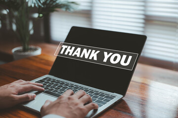 A businessperson interacting with a digital thank you message on a laptop, representing appreciation, gratitude, positive communication, customer relationships, and professional acknowledgment.
