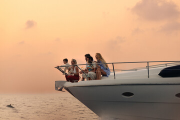 Luxury dolphin-watching cruise at sunset on a family vacation