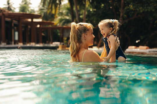 Mother and daughter enjoying a luxurious vacation swimming together