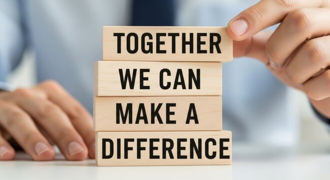 Together We Can Make A Difference: A person meticulously places wooden blocks, crafting an inspiring message of unity and collaborative impact.