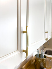 Gold Metal Cabinet Handles on White Kitchen Doors