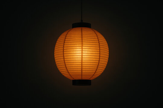 Japanese paper lantern illuminating dark zen background