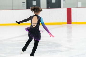 Figure skating practice at an indoor skating rink