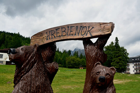A closeup of craved wooden bears and Hrebienok sign at Vysoke Tatry, Hrebienok, High Tatras, Slovakia