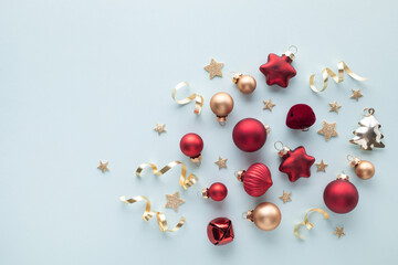 Light blue background decorations festive bauble and stars for Christmas and New Year greeting card
