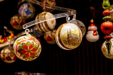 Christmas decoration with ornaments lights fir branches golden baubles red ribbons and festive details creating holiday atmosphere indoor seasonal design bright colorful winter celebration style scene