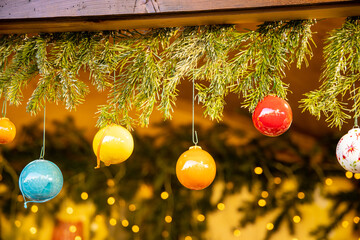 Christmas decoration with ornaments lights fir branches golden baubles red ribbons and festive details creating holiday atmosphere indoor seasonal design bright colorful winter celebration style scene