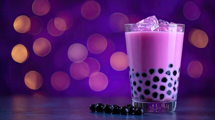 Pink bubble tea in a glass with ice.
