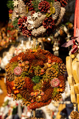 Christmas decoration with ornaments lights fir branches golden baubles red ribbons and festive details creating holiday atmosphere indoor seasonal design bright colorful winter celebration style scene