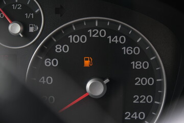 Yellow fuel icon on car dashboard speedometer, rising fuel costs and inflation concept, gasoline and auto.