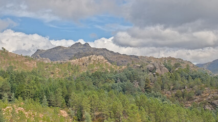 Naklejka premium Cloudy mountain landscape with rocks and pine trees in Penada-Geres national park, Portugall 