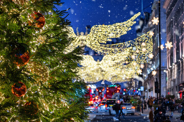 Christmas decorations in central London, England, during night time with blurred street traffic and...