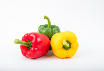 Green , yellow and red bell pepper on a white background.