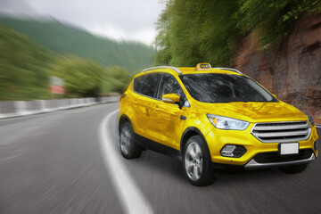 Yellow taxi car with top sign driving on road. Motion blur effect