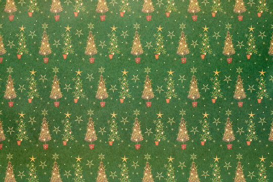 Green Christmas background with snowflakes and christmas trees and stars,seamless pattern of christmas trees and snowflakes on green background,Christmas wrapping paper, Xmas pattern with ornaments.