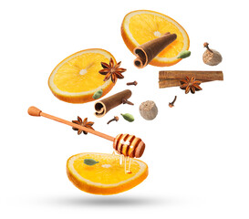 Spices, honey and orange slices for mulled wine falling on white background