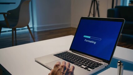 A Person Formatting a Laptop At Home. DIY Home Tech Fix and System Reset.