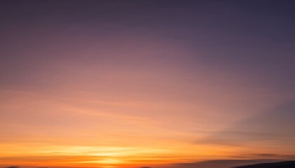 Bright colorful sky during sunset, fully blurred into smooth gradient tones, creating a soft and dreamy atmospheric background.