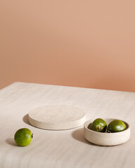 Stone podium with green guava fruits on peach background 3D render