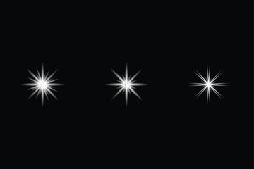 Fototapeta premium Three white star light flare effects on a black background