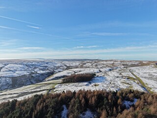 Aerial view of mountains and countryside on a cold winters day with frost and low clouds. Taken in Bury Lancashire England. 