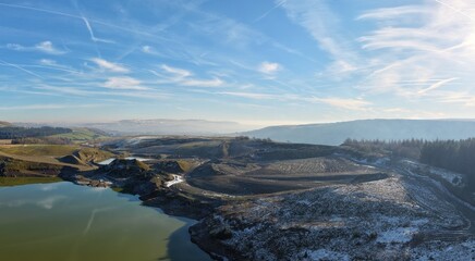 Aerial view of mountains and countryside on a cold winters day with frost and low clouds. Taken in...