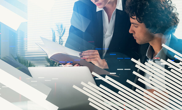 Two business professionals reviewing documents together in a modern office with abstract digital graphic overlay, representing teamwork and technology concept