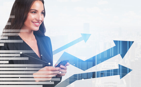 Smiling businesswoman holding smartphone in front of digital arrows and bar charts overlay, on bright city background. Concept of business growth - Powered by Adobe