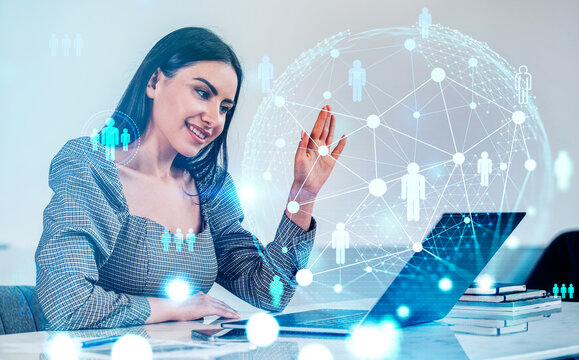 Smiling woman using laptop with holographic people icons and digital network graphics overlay on light background, concept of virtual communication